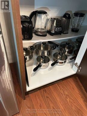 Toronto (Mount Pleasant West) condo for rent - A kitchen cabinet with pots and pans on it.