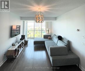 Toronto (Willowdale East) condo for rent - A living room with a grey couch and a chandelier.