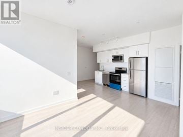 Toronto (Humber Heights) condo for rent - A kitchen with white cabinets and stainless steel appliances.