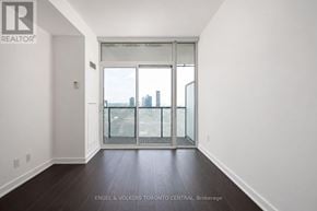 Toronto (Waterfront Communities) condo for rent - A room with a view of the city through a glass door.