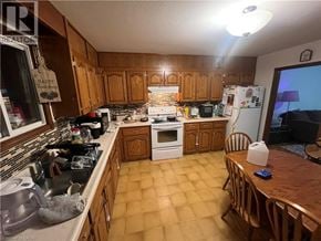 Cambridge apartment for rent - A kitchen with wooden cabinets and a white refrigerator.
