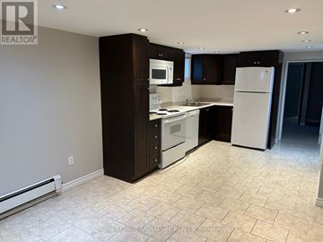 Toronto (Wexford-Maryvale) apartment for rent - A kitchen with a white refrigerator and white tiled flooring.