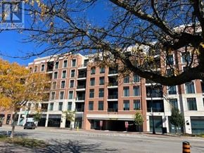 Collingwood condo for rent - A large apartment building is shown with a tree in the foreground.