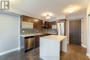 Toronto (Islington-City Centre West) condo for rent - A modern kitchen with stainless steel appliances and wooden cabinets.