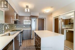 Toronto (Islington-City Centre West) condo for rent - A modern kitchen with a white countertop and stainless steel appliances.