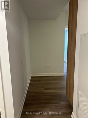 Vaughan (Concord) condo for rent - A hallway with wood floors and white walls.