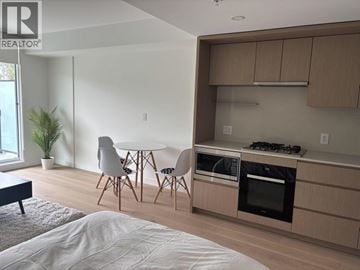 Vancouver apartment for rent - A modern kitchen with a dining table and chairs.