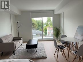 Vancouver apartment for rent - A living room with a couch, chairs, and a table.