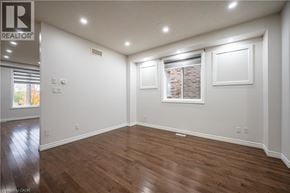 Waterloo apartment for rent - A spacious room with wooden flooring and white walls.
