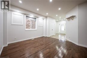 Waterloo apartment for rent - A spacious room with wooden flooring and white walls.