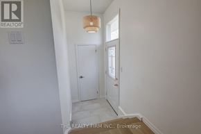 London South (South D) apartment for rent - A hallway with a door and a light hanging from the ceiling.