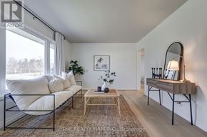 London South (South D) apartment for rent - A living room with a white sofa, a wooden coffee table, and a mirror on the wall.