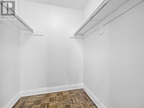 Toronto (Briar Hill-Belgravia) condo for rent - A white room with a wood floor and a white wall.