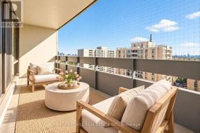 Toronto (Briar Hill-Belgravia) condo for rent - A balcony with a table and chairs overlooking a cityscape.