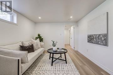 London South (South D) apartment for rent - A living room with a couch, a coffee table, and a painting on the wall.