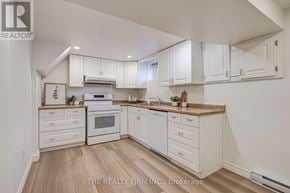 London South (South D) apartment for rent - A white kitchen with wooden floors and white cabinets.