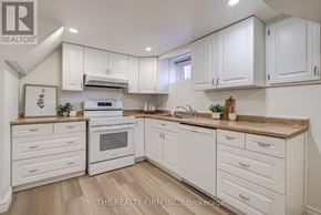 London South (South D) apartment for rent - A white kitchen with wooden floors and a large island.