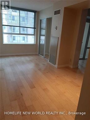 Toronto (Bay Street Corridor) condo for rent - A room with wooden flooring and a large window.