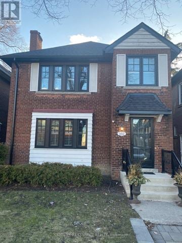 Toronto (Lawrence Park South) apartment for rent - A house with a brick facade and a black door.