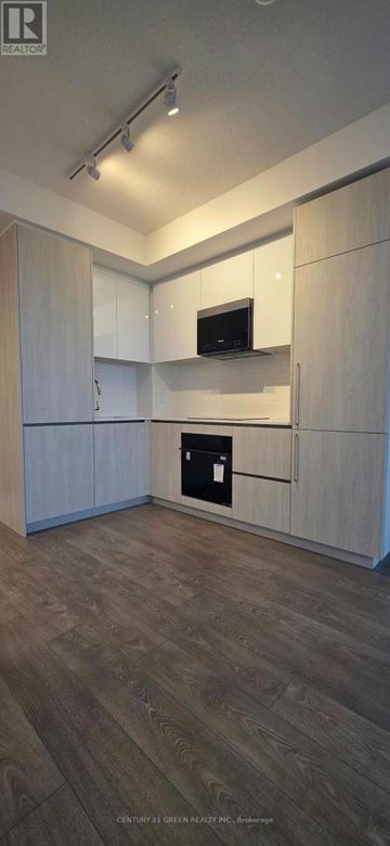 Brampton (Fletcher's Creek South) condo for rent - A kitchen with white cabinets and a microwave.