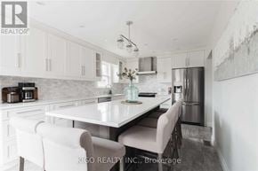 Burlington (Mountainside) apartment for rent - A modern kitchen with white cabinets and a central island.