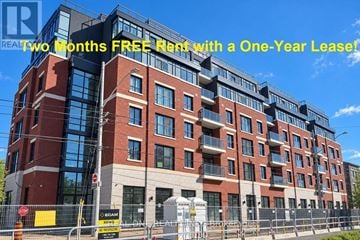 Hamilton (Westdale) condo for rent - A modern apartment building with a sign offering two months free rent with a one-year lease.