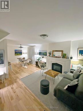 Toronto (Rosedale-Moore Park) apartment for rent - A living room with a fireplace and a grey couch.