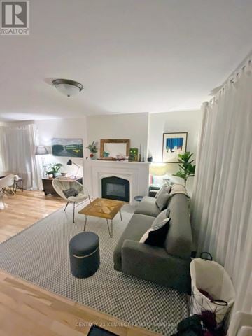Toronto (Rosedale-Moore Park) apartment for rent - A living room with a grey couch and a wooden coffee table.