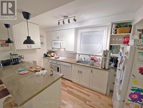Toronto (Rosedale-Moore Park) apartment for rent - A kitchen with white cabinets and a white fridge.