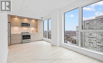 Toronto (Islington-City Centre West) condo for rent - A spacious living room with a television and a large window overlooking a cityscape.