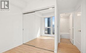 Toronto (Islington-City Centre West) condo for rent - A room with a sliding glass door leading to a balcony.
