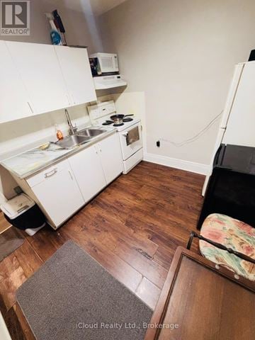 Hamilton (Crown Point) apartment for rent - A kitchen with white cabinets and a wooden floor.