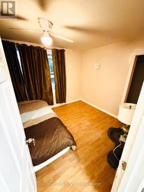 Hamilton (Crown Point) apartment for rent - A bedroom with a bed, a ceiling fan, and a window with curtains.
