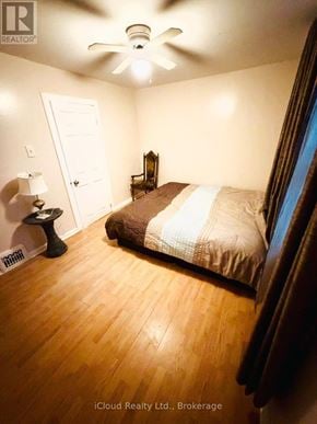 Hamilton (Crown Point) apartment for rent - A bedroom with a bed, a lamp, and a ceiling fan.