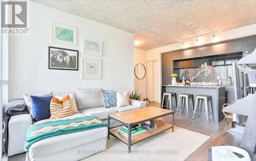 Toronto (Waterfront Communities) condo for rent - A living room with a white couch and a coffee table.