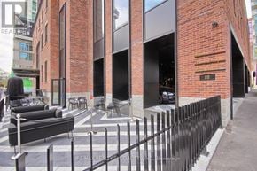Toronto (Waterfront Communities) condo for rent - A black metal fence surrounds a brick building.