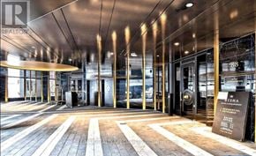 Toronto (Waterfront Communities) condo for rent - The lobby of a building with a wooden floor and a glass ceiling.