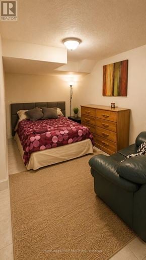 Richmond Hill (Crosby) apartment for rent - A bedroom with a bed, dresser, and chair.