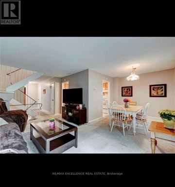 London South (South R) townhouse for rent - A living room with a glass coffee table and a white chair.