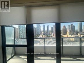 Mississauga (City Centre) condo for rent - A window with a view of a city skyline.