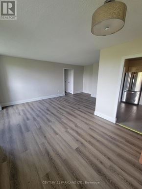 Toronto (Flemingdon Park) condo for rent - A room with wooden flooring and a light fixture on the ceiling.