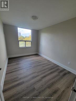 Toronto (Flemingdon Park) condo for rent - A room with wooden flooring and a window that lets in light.