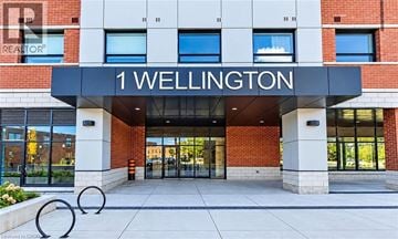 Brantford condo for rent - The front of a building with the name "1 Wellington" on it.