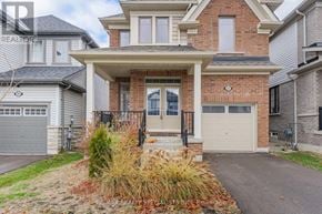 Centre Wellington (Fergus) apartment for rent - A house with a brick facade and a grey garage door.
