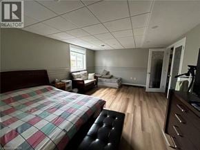 Kitchener apartment for rent - A bedroom with a bed, a couch, and a TV.
