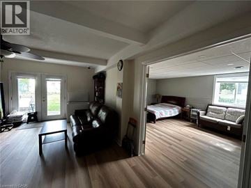 Kitchener apartment for rent - A living room with a couch and a bedroom with a bed and a dresser.