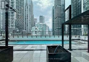 Toronto (Waterfront Communities) condo for rent - A pool on a balcony with a cityscape in the background.