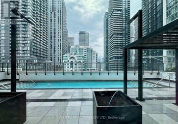 Toronto (Waterfront Communities) condo for rent - A pool on a balcony with a cityscape in the background.