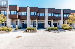 Hamilton (Stoney Creek) townhouse for rent - A building with the text "HOMELIFE MIRACLE REALTY LTD Brokerage" on the front.