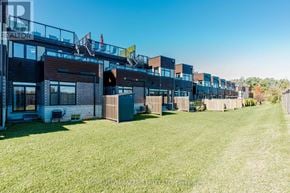 Hamilton (Stoney Creek) townhouse for rent - A row of houses with a grassy lawn in front.
